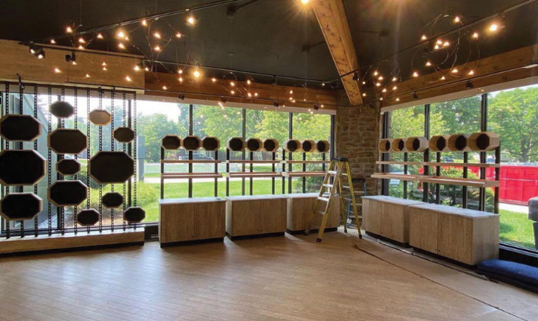 Interior view of a modern retail space featuring hemp wood displays, natural lighting from large windows, and wooden shelving, showcasing eco-friendly building materials by HempWood.
