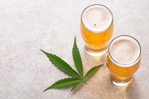 two glasses of beer and a cannabis leaf